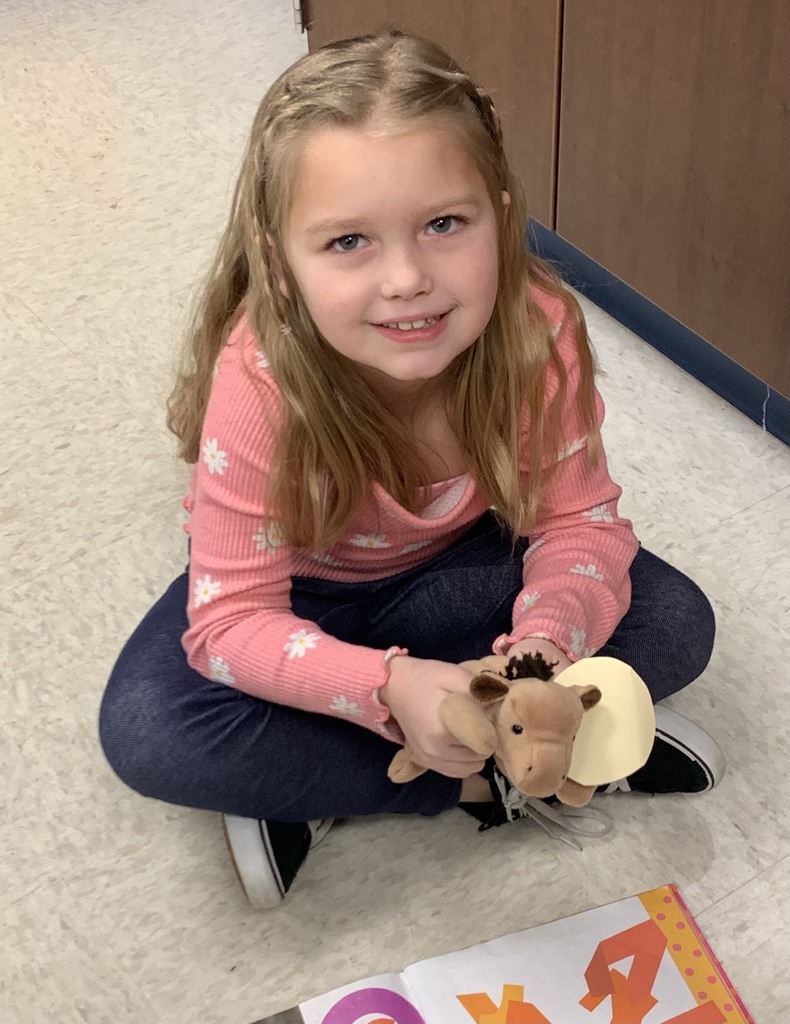 girl holding a stuffed animal