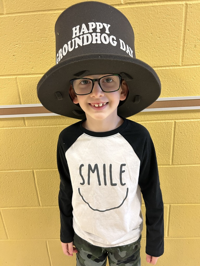 student wearing hat that reads "Happy Groundhog Day"