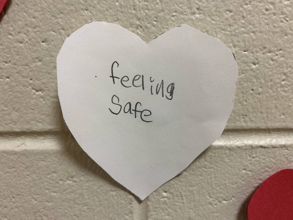 heart with writing that says "feeling safe"
